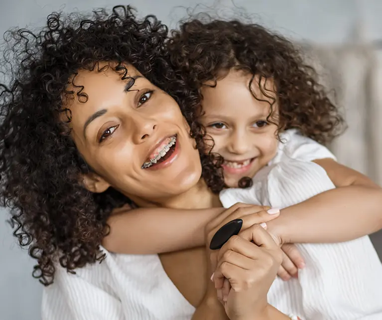 Mother and daughter smiling