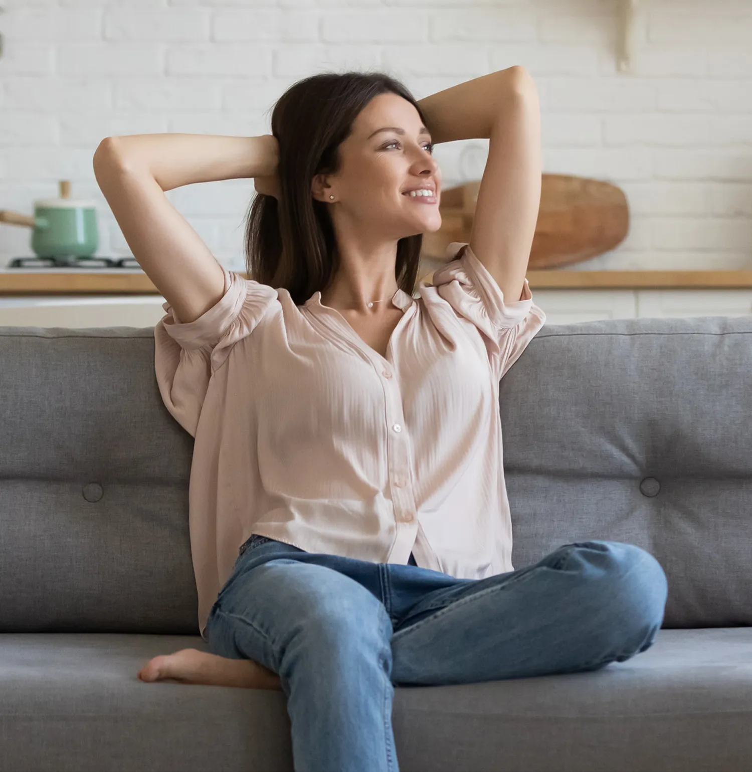 Woman sitting on the couch looking to her left | Pleasantville Smiles