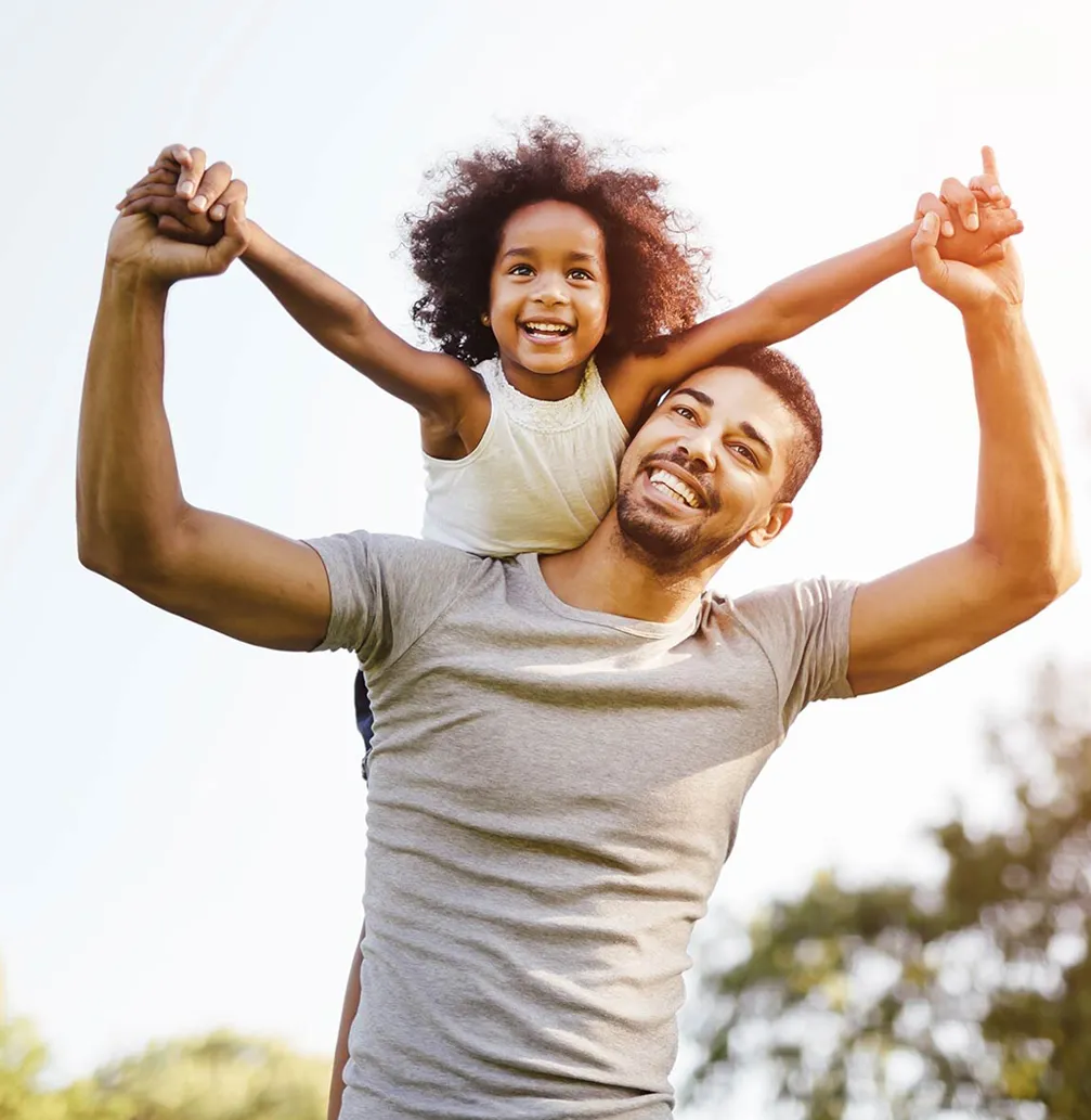 Father and daughter smiling outside