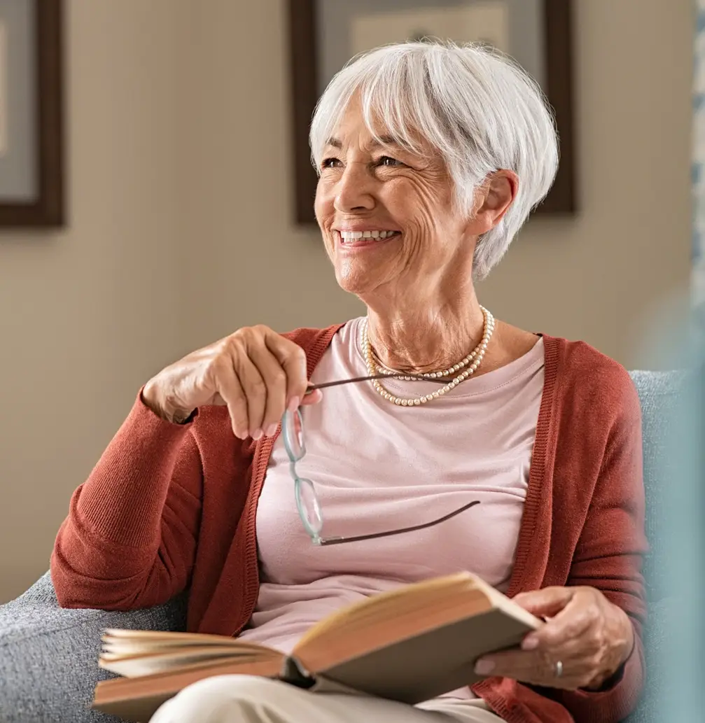 Older woman holding glasses smiling