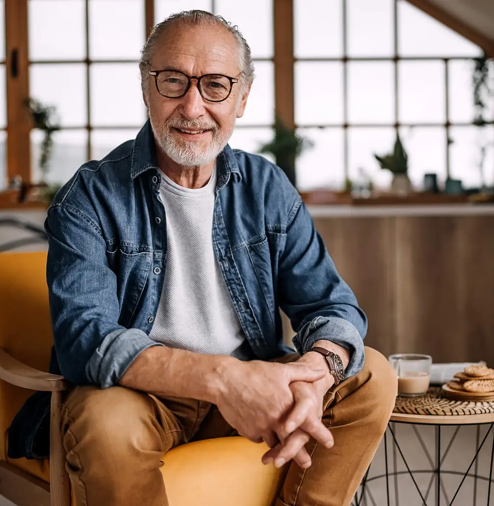 Old man sitting down and smiling