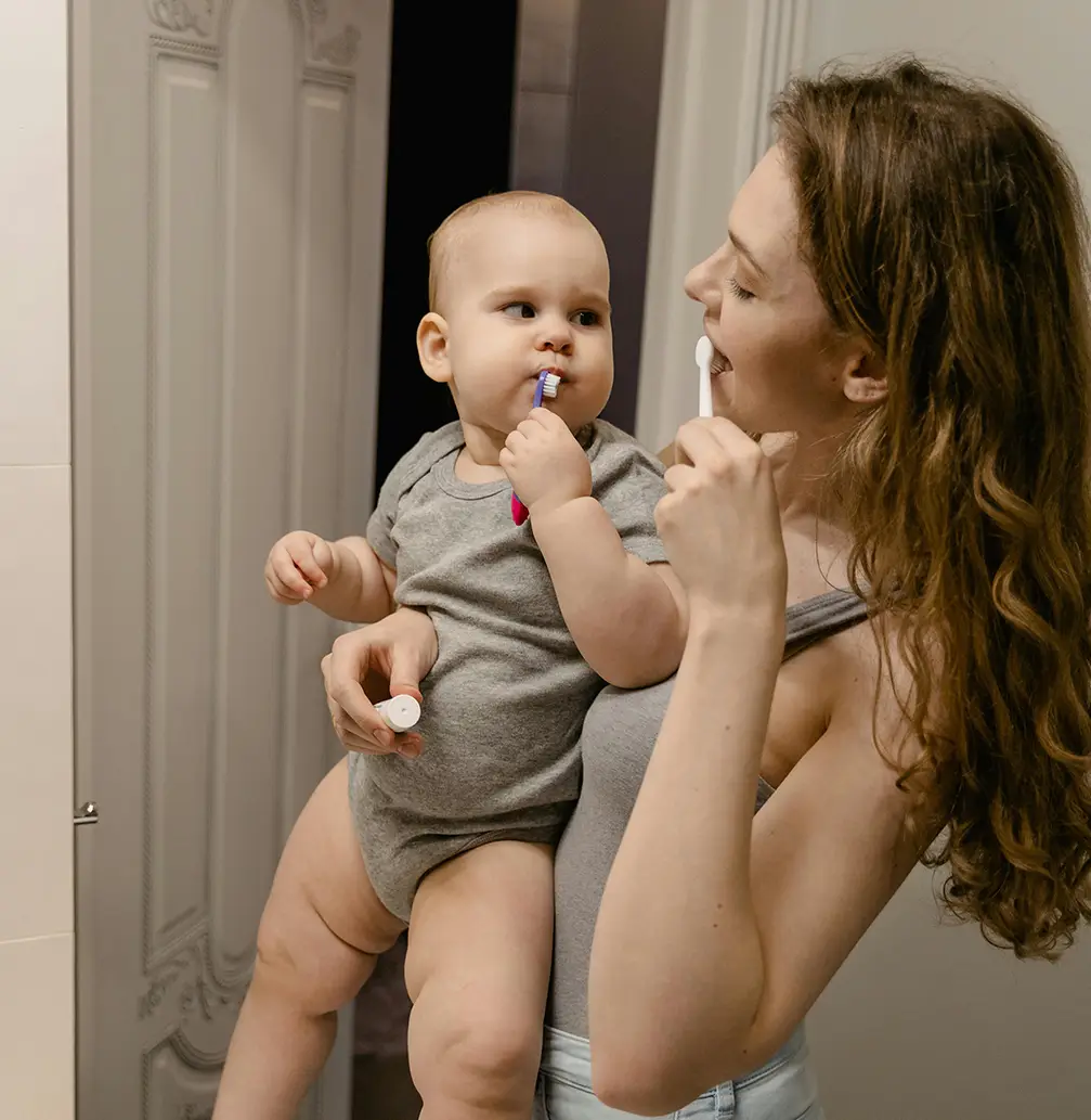 Mom and baby brushing teeth in the bathroom